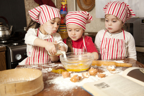 Three little chefs enjoying in the kitchen making big mess. Litt - Foto, Imagem