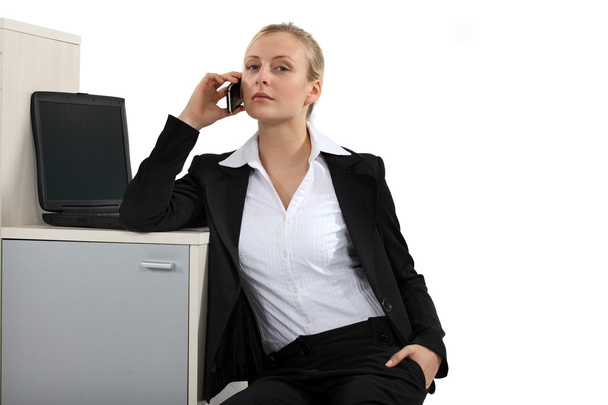 Serious blond businesswoman making a call - Foto, afbeelding