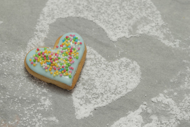 Baked valentine's heart covered with blue icing and confetti - Foto, imagen