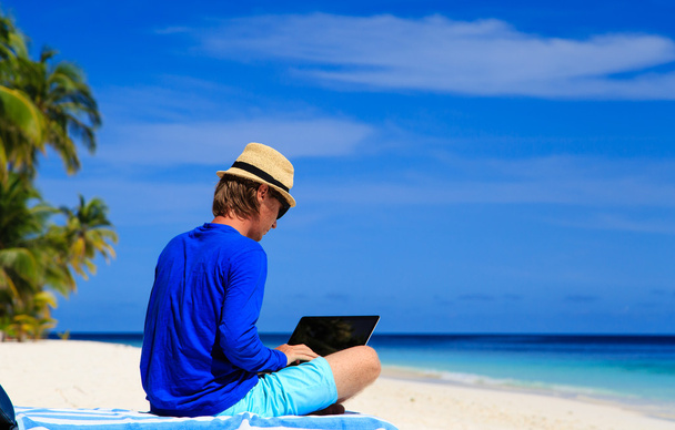 man with laptop on tropical beach - Photo, Image