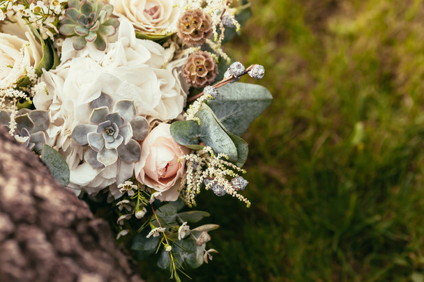 roses, succulents and other flowers in wedding bouquet on green  - Valokuva, kuva