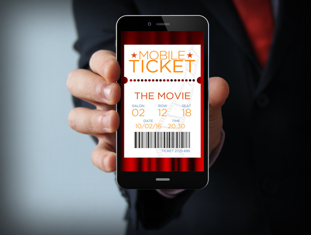 Бизнесмен с билетами в кино через Интернет по телефону
 - Фото, изображение