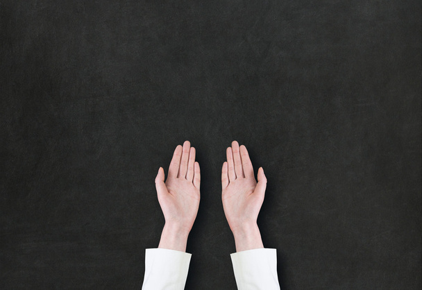 Hand pointing or showing something on blackboard  - 写真・画像