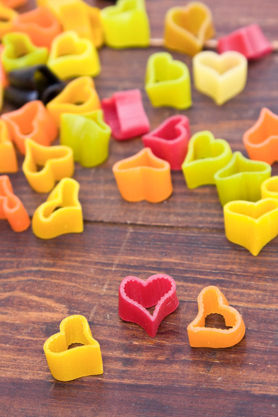 Heart-shaped pasta on wood table - Valokuva, kuva