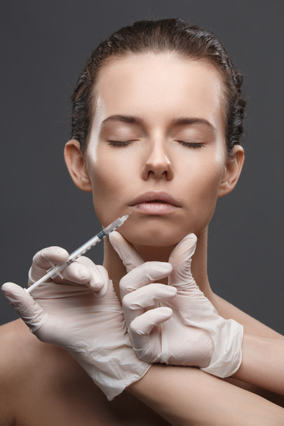 Portrait of young Caucasian woman getting cosmetic injection - Φωτογραφία, εικόνα