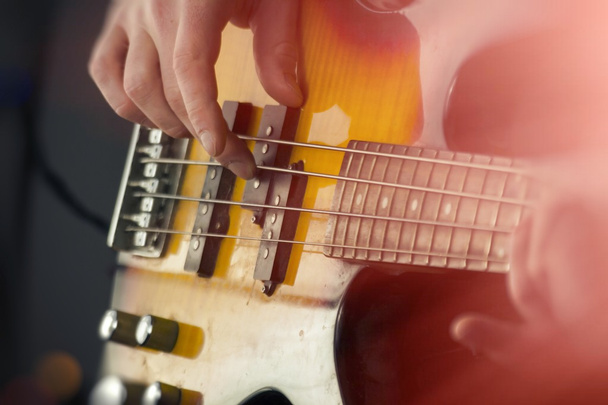 Close Up Playing Bass Guitar - 写真・画像