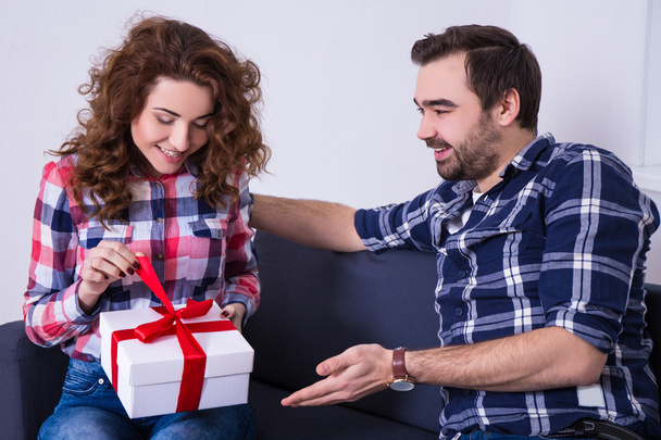 valentine's day concept - young woman opening gift from her boyf - Valokuva, kuva