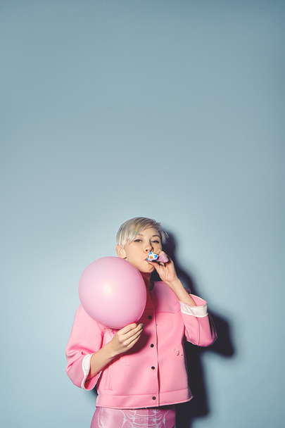 girl have fun with colored balloons on blue background - Photo, Image