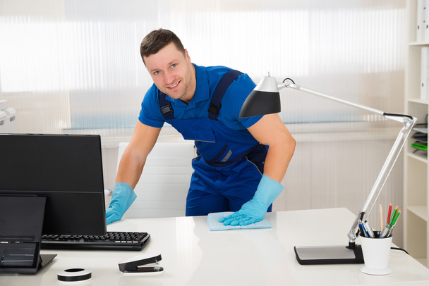 Worker Cleaning Desk With Sponge - Photo, Image