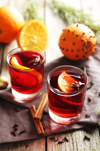 Mulled wine in glass on grey wooden table - Foto, afbeelding