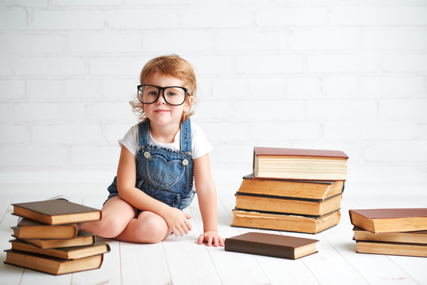 bambina bambina con gli occhiali che legge un libro
 - Foto, immagini