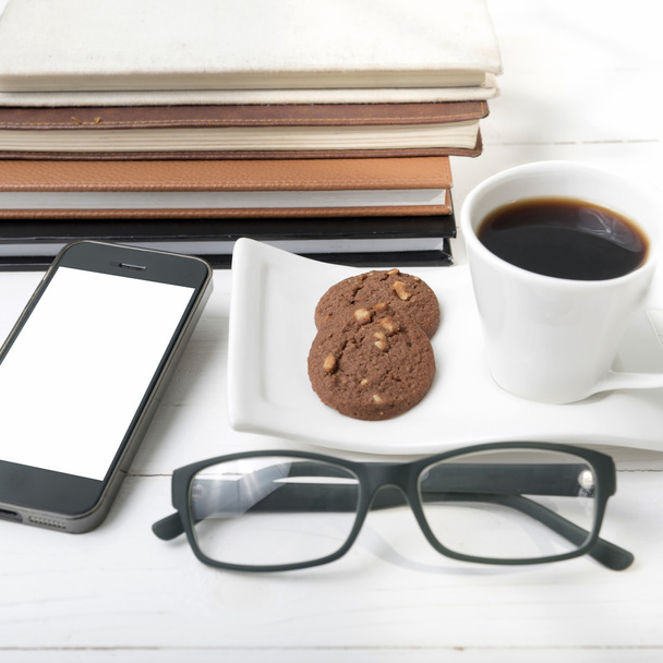 coffee cup with cookie,phone,stack of book and eyeglasses - Φωτογραφία, εικόνα