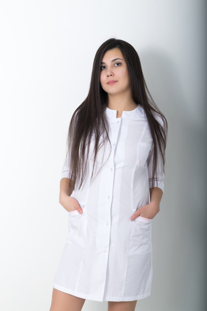 beautiful young asian female doctor in medical gown holding a phonendoscope - Foto, Imagem