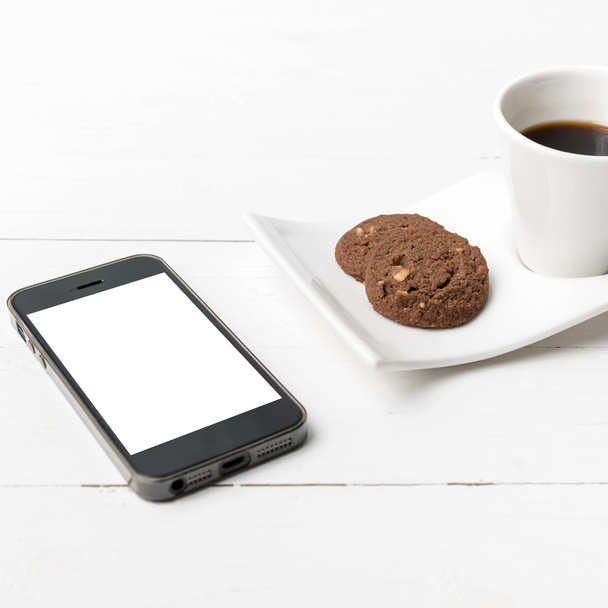 coffee cup with cookie and phone - Photo, Image
