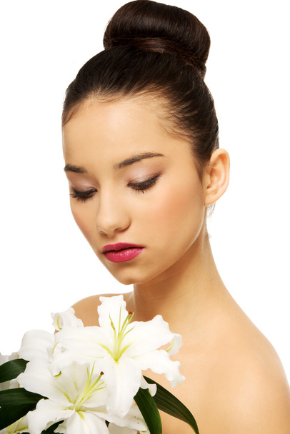 Beauty face of a woman with flower. - Foto, Bild