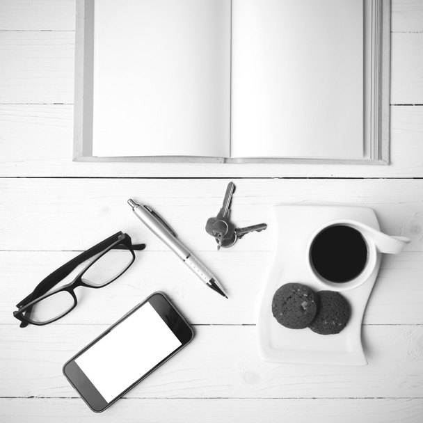 coffee cup with cookie,phone,open notebook,key and eyeglasses bl - Foto, afbeelding