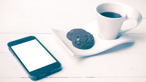 coffee cup with cookie and phone vintage style - 写真・画像