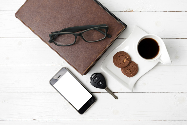 coffee cup with cookie,phone,stack of book and car key  - Foto, imagen