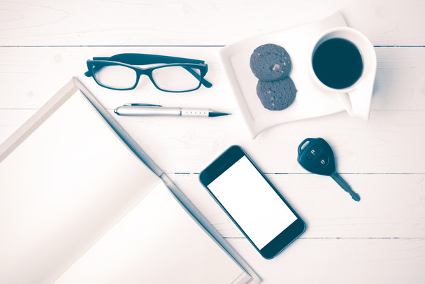 coffee cup with cookie,phone,open notebook,car key and eyeglasse - Photo, image