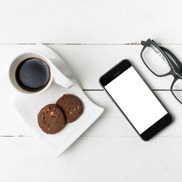 coffee cup with cookie,phone and eyeglasses  - Φωτογραφία, εικόνα