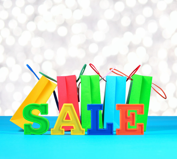 Sale written by colorful letters on the background of shopping b - Photo, Image