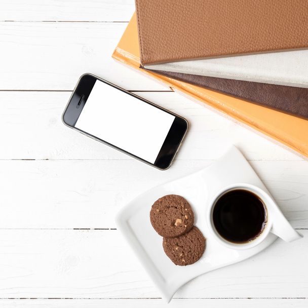 coffe cup with cookie,phone and stack of book - Foto, imagen