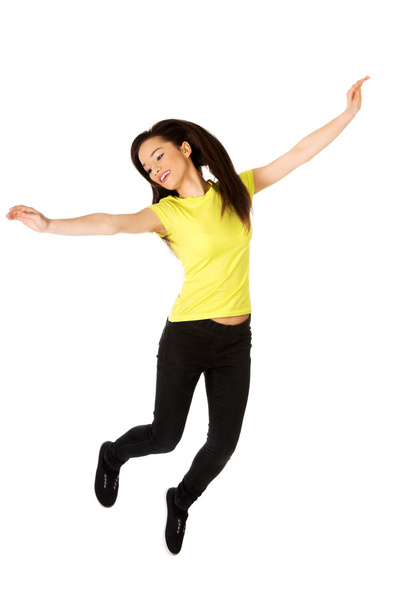 Young casual woman jumping. - Zdjęcie, obraz