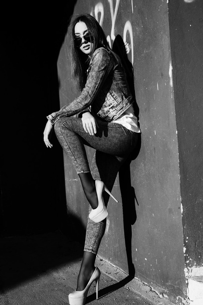 Young woman standing outdoors. fashion portrait. Black and white - Valokuva, kuva