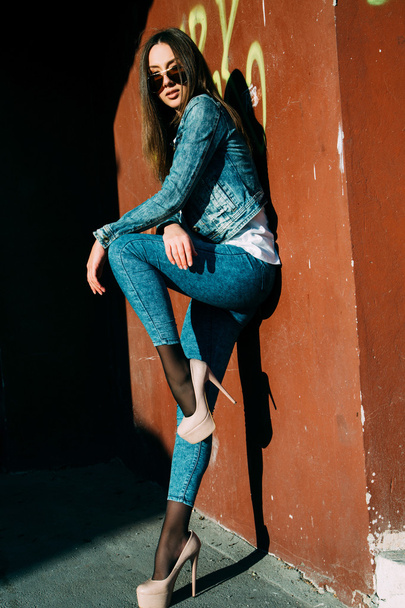Young woman standing outdoors. fashion portrait.  - 写真・画像