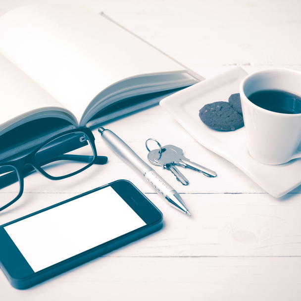 coffee cup with cookie,phone,open notebook,key and eyeglasses vi - Foto, Imagen