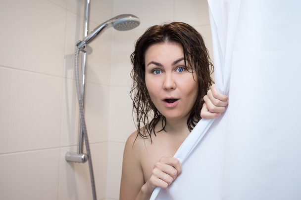 beautiful surprised woman covering her body with curtain in show - Photo, Image