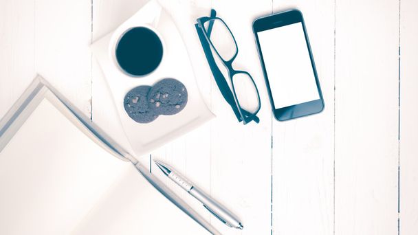 coffee cup with cookie,phone,notebook and eyeglasses vintage sty - Foto, Imagen