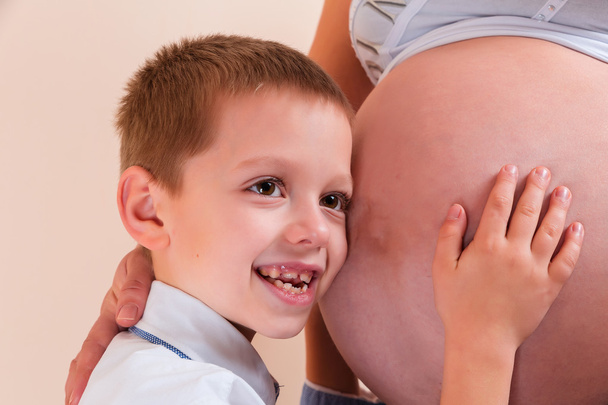 Little boy listening to pregnant mother's belly  - Photo, Image