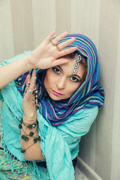 Beautiful oriental woman in a traditional headscarf. - Foto, immagini