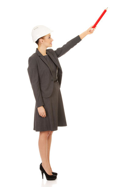 Architect woman pointing up with pencil. - Fotó, kép