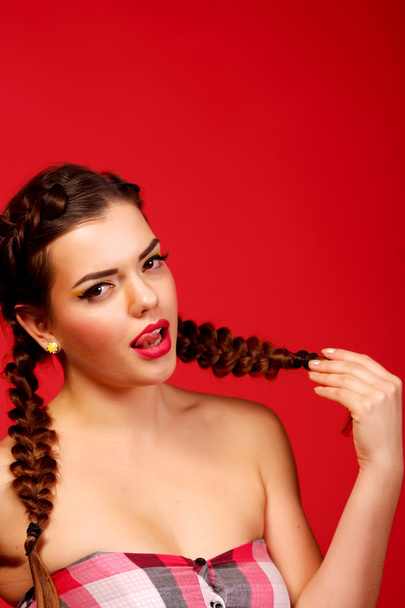 Fashion woman with red lips and smoky eyes, evening make up. Beauty. Portrait. Red background, studio shot. Perfect skin. Brunette. - Φωτογραφία, εικόνα