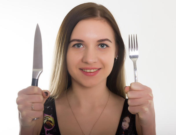 close-up slim girl in a bathing suit, a girl holding a knife and fork. concept hungry girl - Foto, Bild