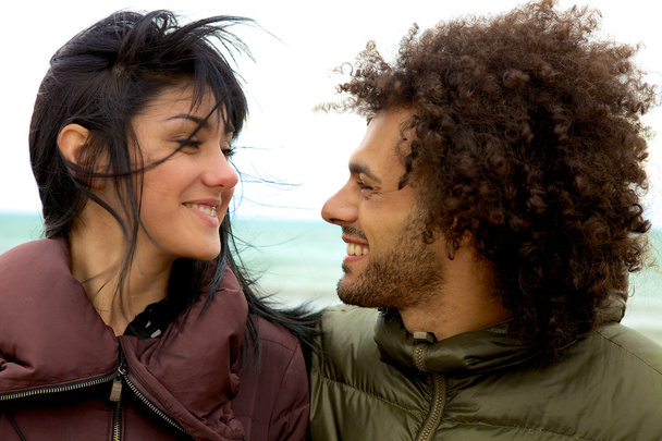 Couple en hiver avec le vent en regardant chaque sourire heureux
 - Photo, image