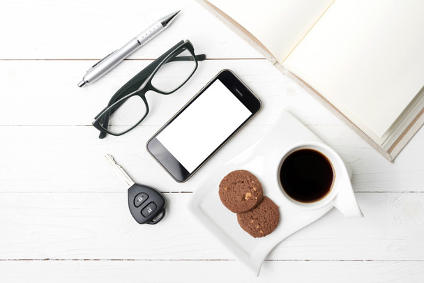 coffee cup with cookie,phone,open notebook,car key and eyeglasse - Foto, imagen