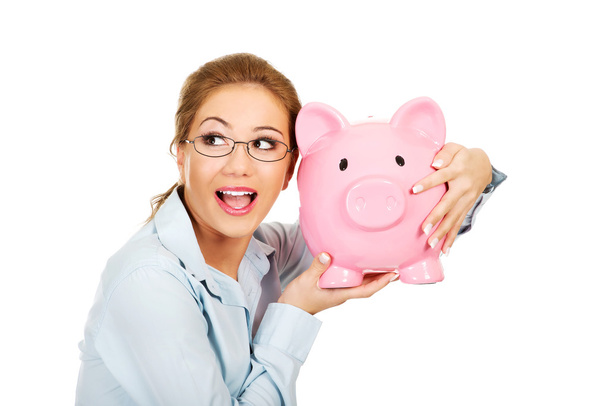 Woman holding piggy bank. - Foto, imagen
