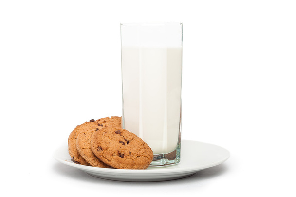 Oat cookies in plate and milk in tall glass isolated on white ba - Foto, Imagen