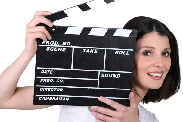 Young woman with a film clapperboard - Zdjęcie, obraz