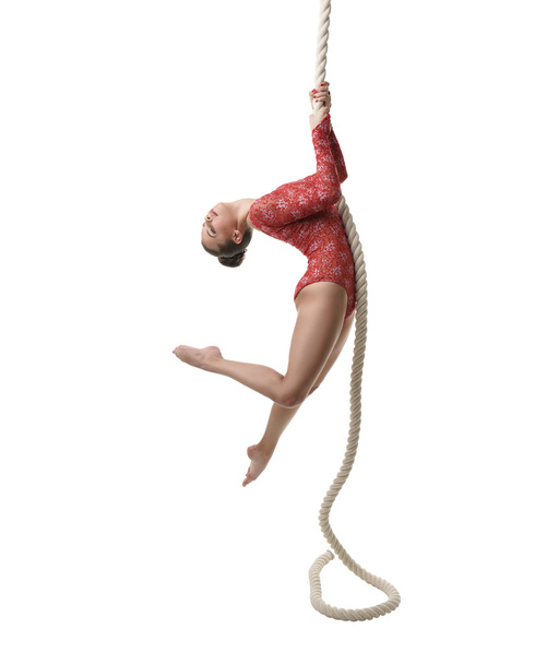 Image of graceful female gymnast hanging on rope - Foto, afbeelding