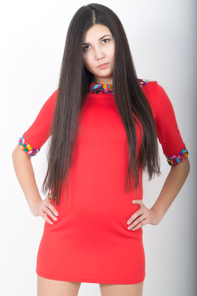 young pretty slim asian woman standing in a little red dress - Fotó, kép