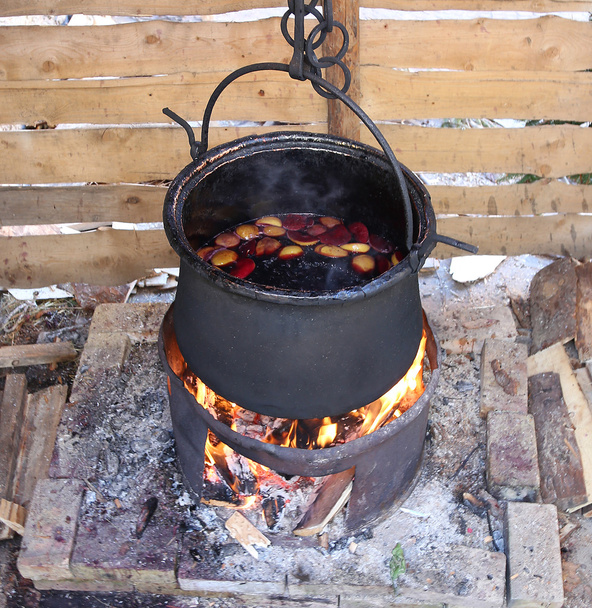 big blackened pot to cook the tasty mulled wine in the european  - Photo, Image
