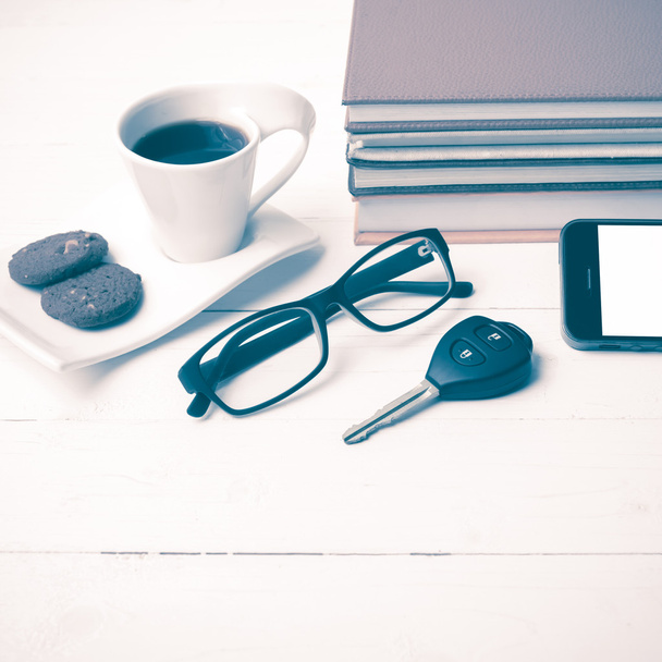 coffe cup with cookie,phone,car key,eyeglasses and stack of book - Foto, Imagen