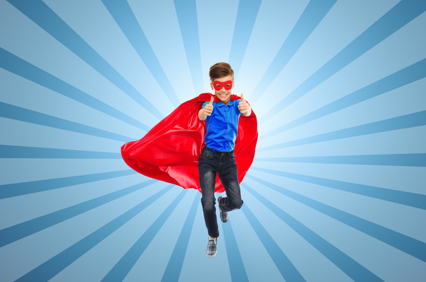 boy in super hero cape and mask showing thumbs up - Fotó, kép