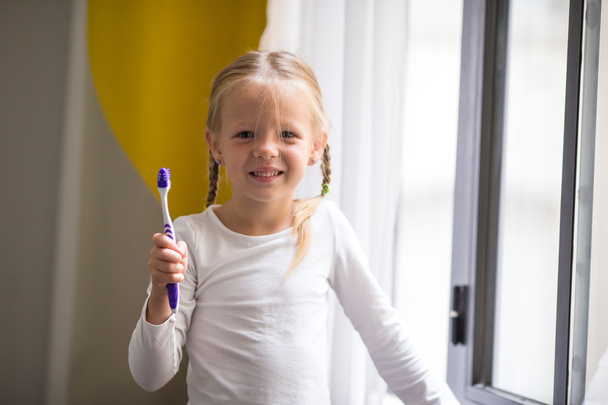 Dental hygiene. Adorable little smile girl brushing her teeth - Photo, image
