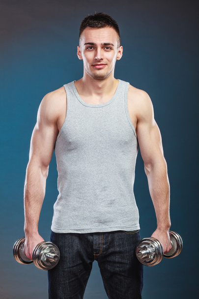 athletic man working with heavy dumbbells - Photo, Image