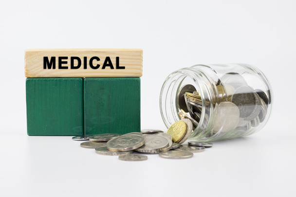 Coins in glass jar with MEDICAL label, financial concept - Photo, Image
